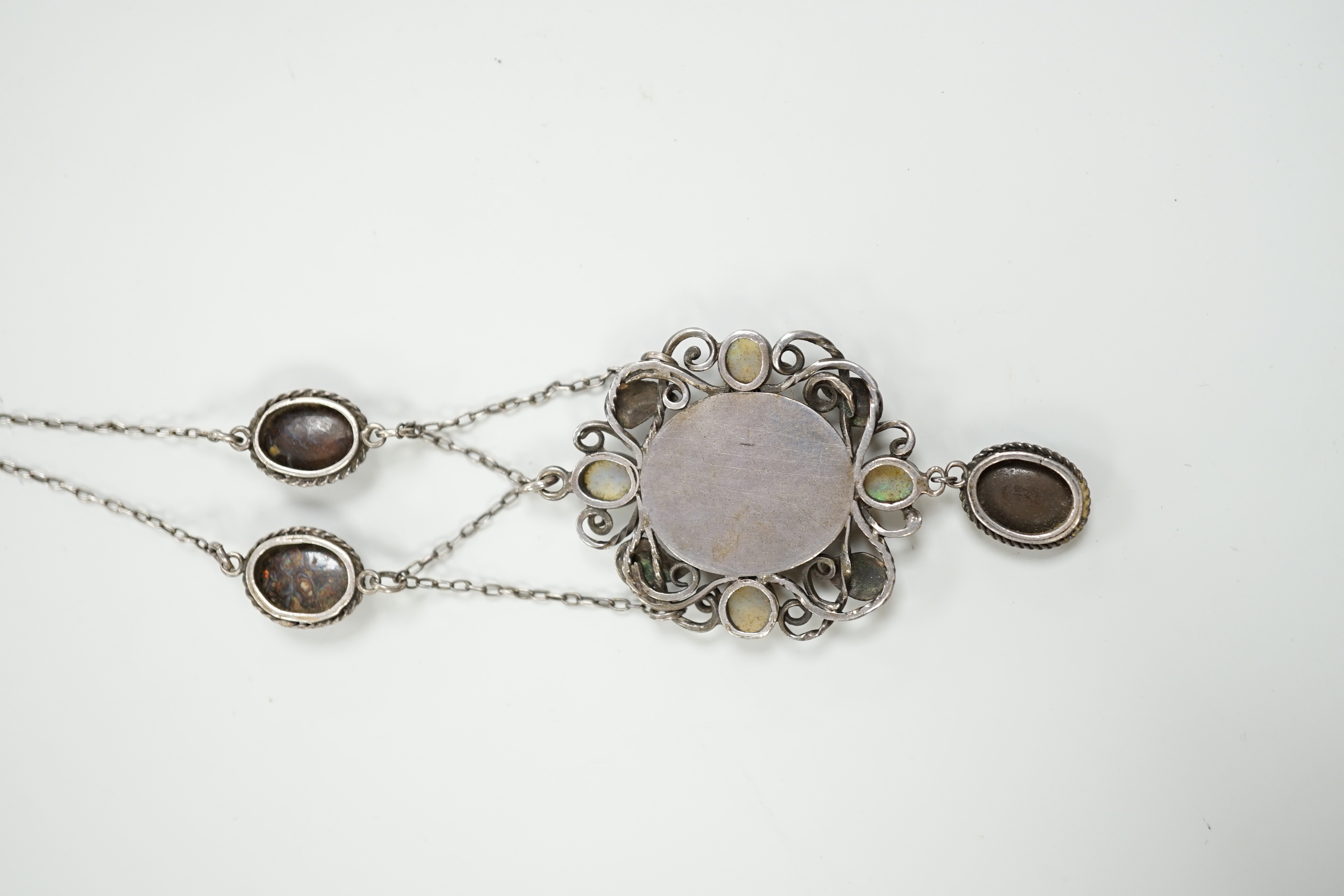 An Arts & Crafts white metal, mother of pearl and gem set drop pendant necklace, in the manner of Sybil Dunlop, overall 56cm.